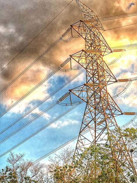 Low angle view of power lines against cloudy sky