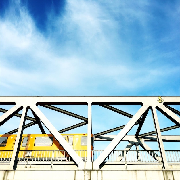 Low angle view of railway bridge against blue sky