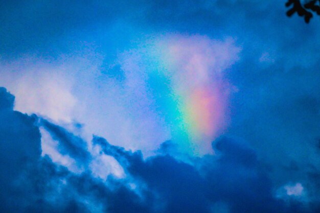 Low angle view of rainbow against blue sky