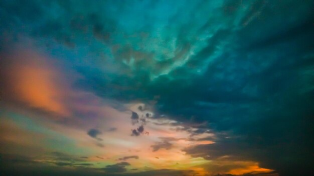 Low angle view of rainbow against cloudy sky