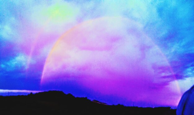 Low angle view of rainbow in sky