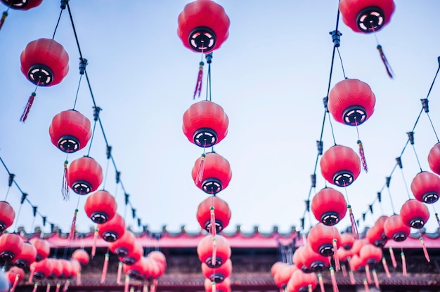 Low angle view of red lanterns at temple against sky