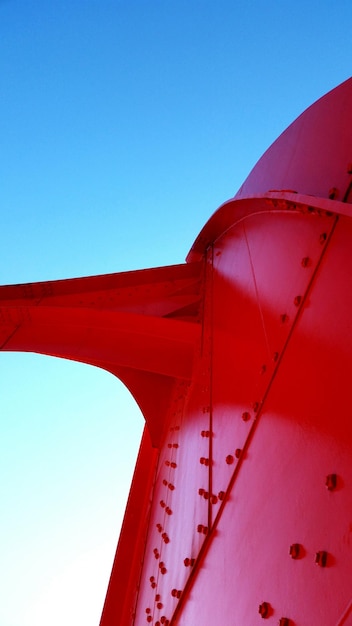 Low angle view of red sculpture against clear sky