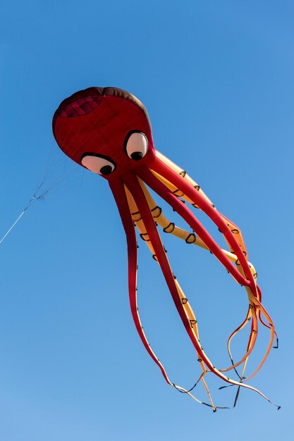 Foto vista a basso angolo di un ombrello rosso contro un cielo blu limpido