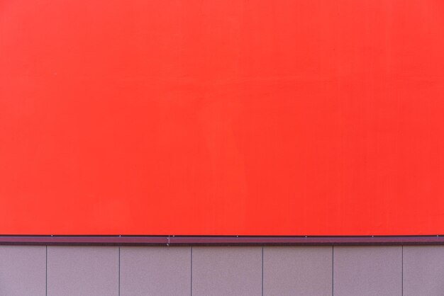 Low angle view of red wall with orange building