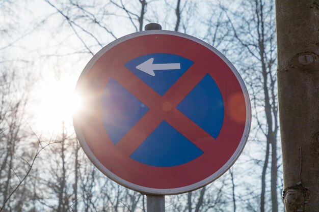 Low angle view of road sign against blue sky