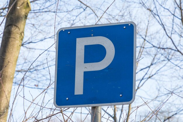 Low angle view of road sign against blue sky