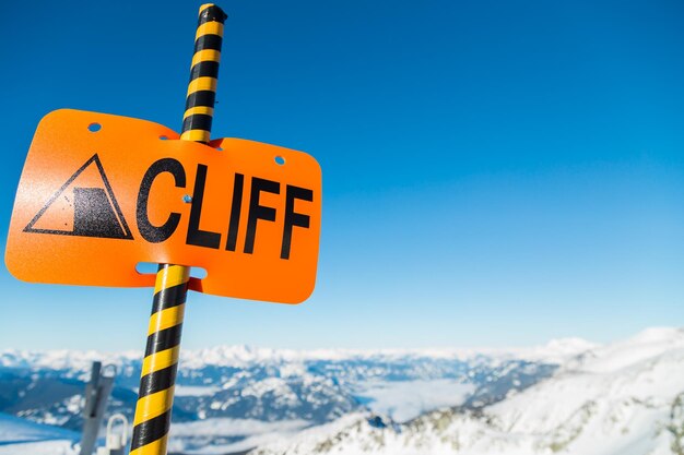 Low angle view of road sign against blue sky