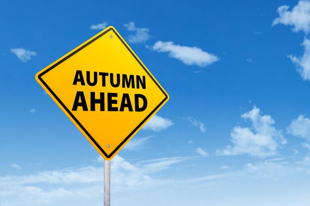 Low angle view of road sign against blue sky