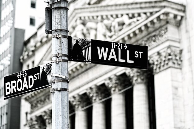 Low angle view of road sign against buildings in city