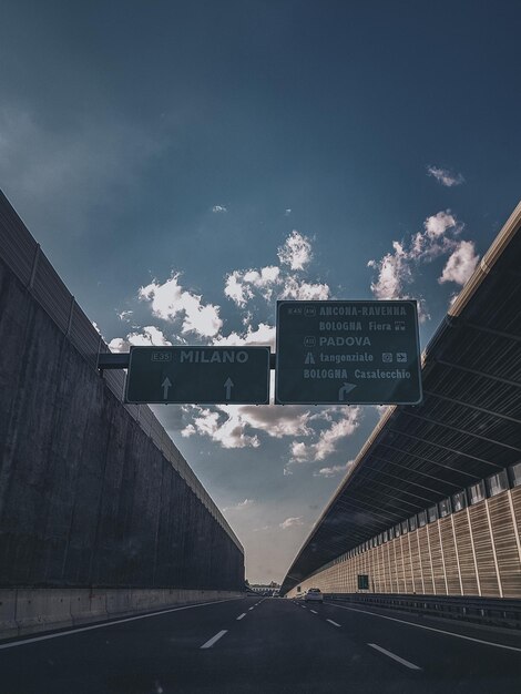 Low angle view of road sign against sky