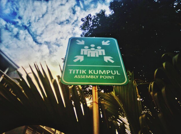 Low angle view of road sign against sky