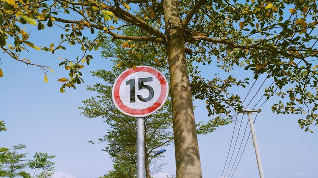 Low angle view of road sign against sky