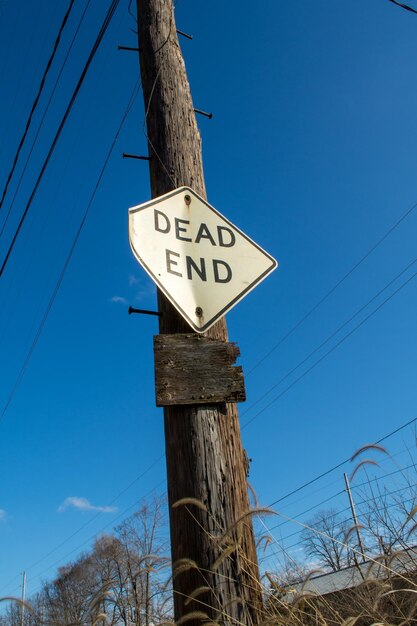 Low angle view of road sign against sky