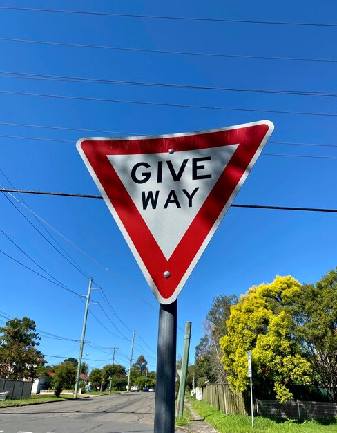 Low angle view of road sign against sky