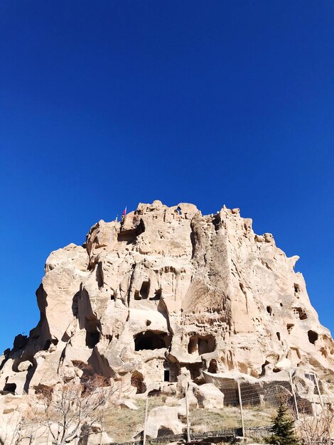 Low angle view of rock formation against blue sky