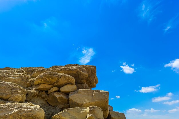 Low angle view of rock formation against blue sky