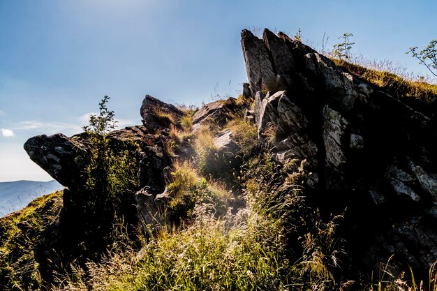 Low angle view of rock formation on mountain against sky