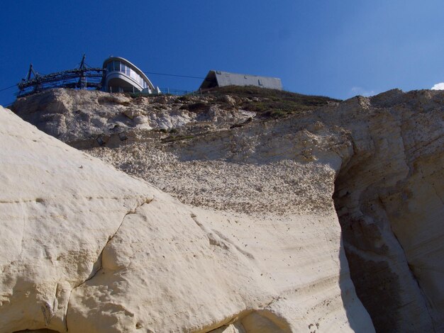 Low angle view of rock formations against sky