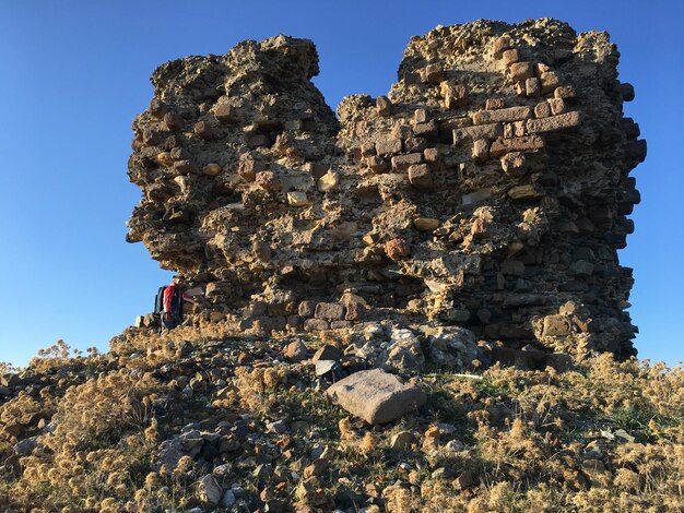 Low angle view of rock formations against sky