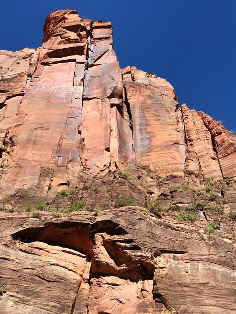 Low angle view of rocks on mountain against sky