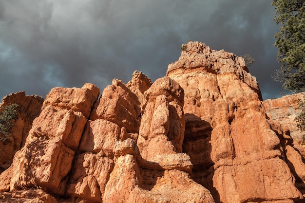 Low angle view of rocks on mountain against sky