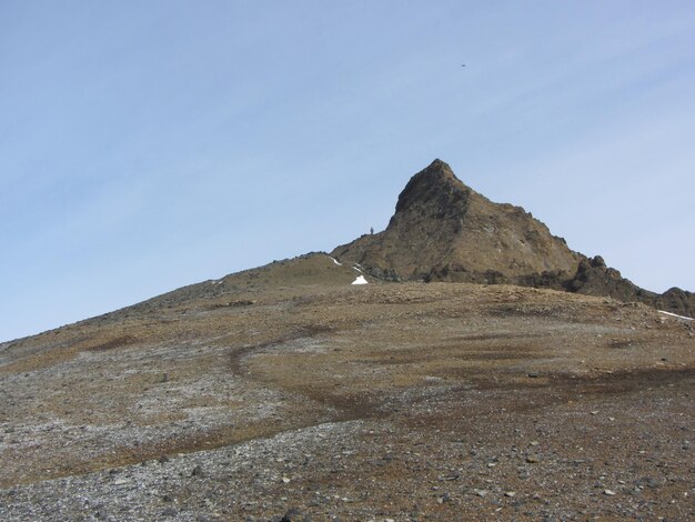 Low angle view of rocky mountain against clear sky