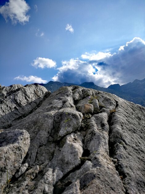 Low angle view of rocky mountains against sky