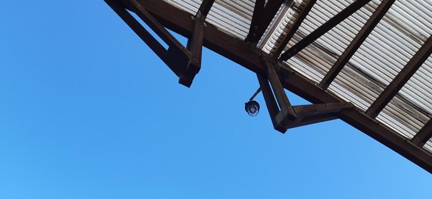 Low angle view of roof against clear blue sky