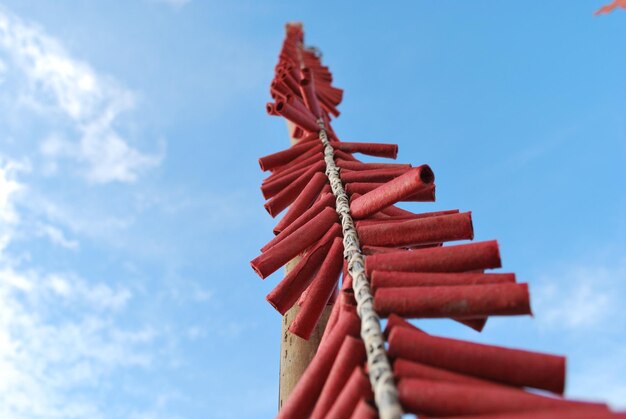 Low angle view of rope tied against sky