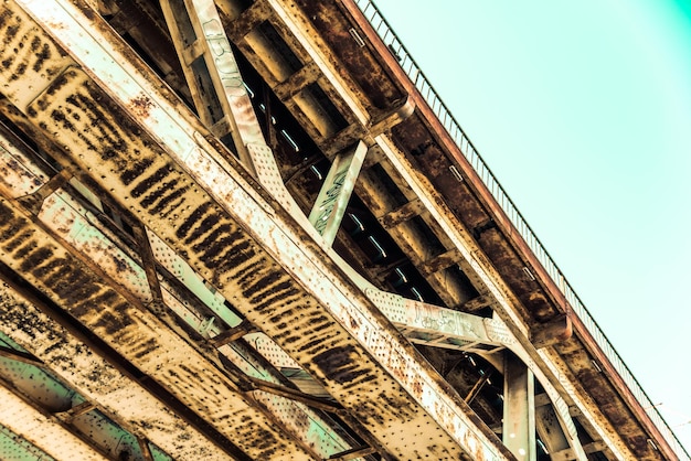 Low angle view of rusty bridge against sky