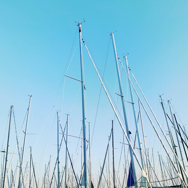 Low angle view of sailboat against clear blue sky