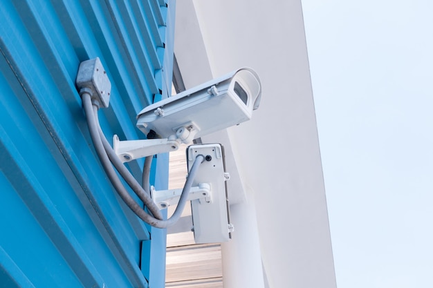 low angle view of security camera mounted on wall
