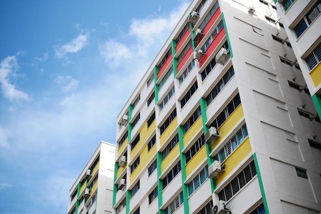 Low angle view of signapore residential buildings against blue sky