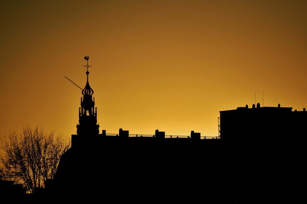 Low angle view of silhouette building against sky during sunset