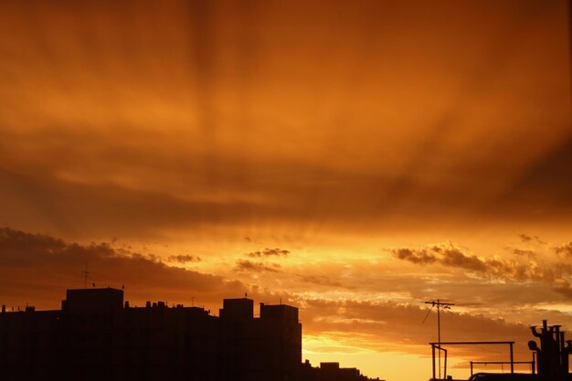 Low angle view of silhouette buildings against sky during sunset