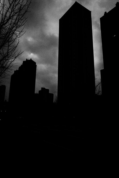 Low angle view of silhouette buildings against sky at dusk