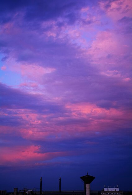 Low angle view of silhouette buildings against sky at sunset