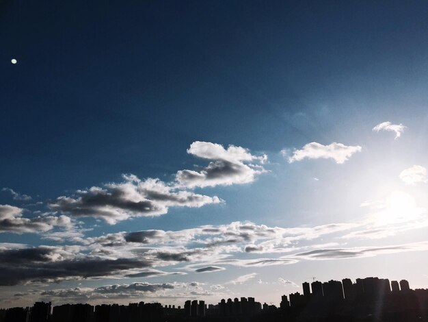 Low angle view of silhouette buildings against sky