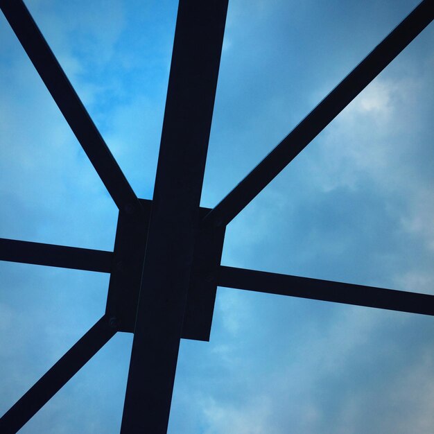 Low angle view of silhouette built structure against blue sky