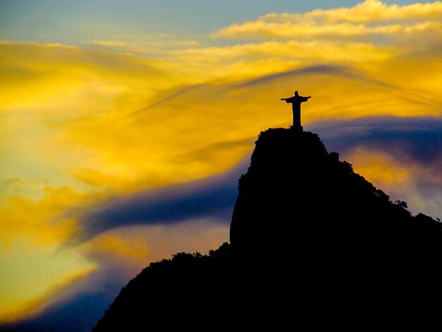 Low angle view of silhouette christ the redeemer against sky during sunset