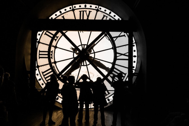 Low angle view of silhouette clock on ceiling