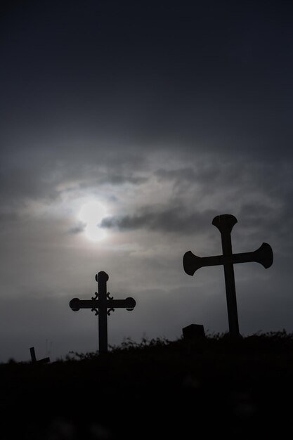 Low angle view of silhouette cross against sky during sunset