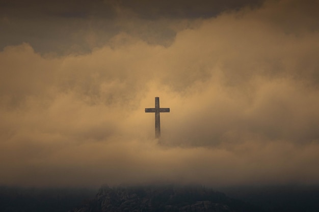 low angle view of silhouette cross against sky during sunset