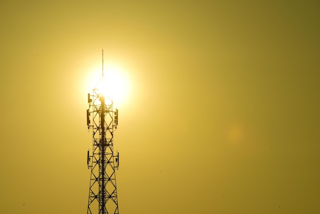 Low angle view of silhouette electricity pylon against sky during sunset