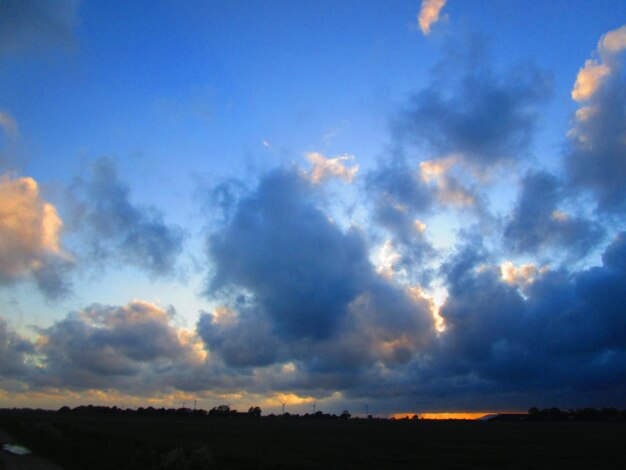 Low angle view of silhouette landscape against sky during sunset