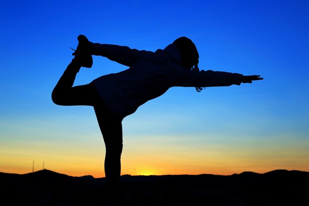 Low angle view of silhouette man against clear sky during sunset