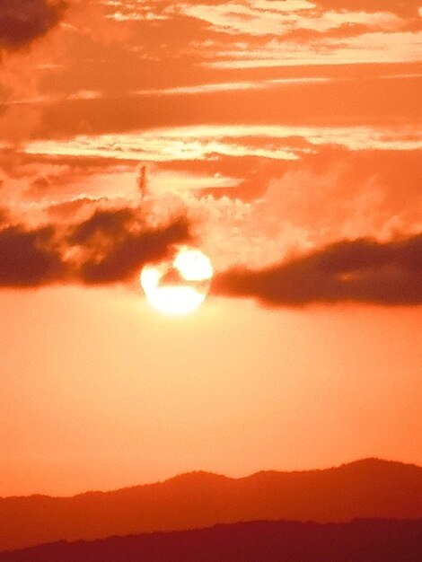 Low angle view of silhouette mountain against romantic sky at sunset