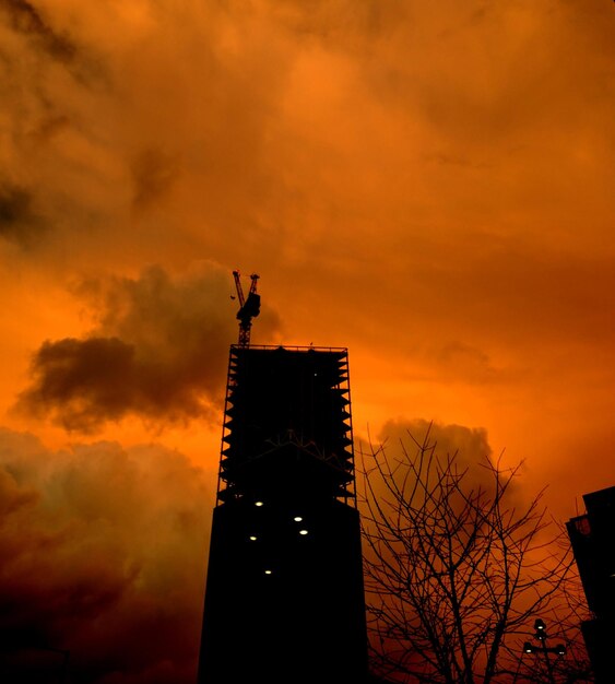 Low angle view of silhouette statue against sky during sunset