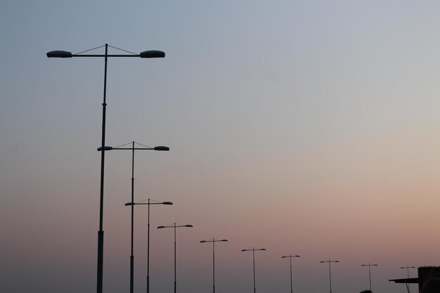 Low angle view of silhouette street light against sky during sunset